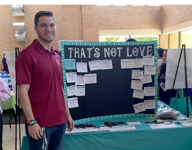 Fraternity member tabling "That's Not Love" info at Take Back the Night