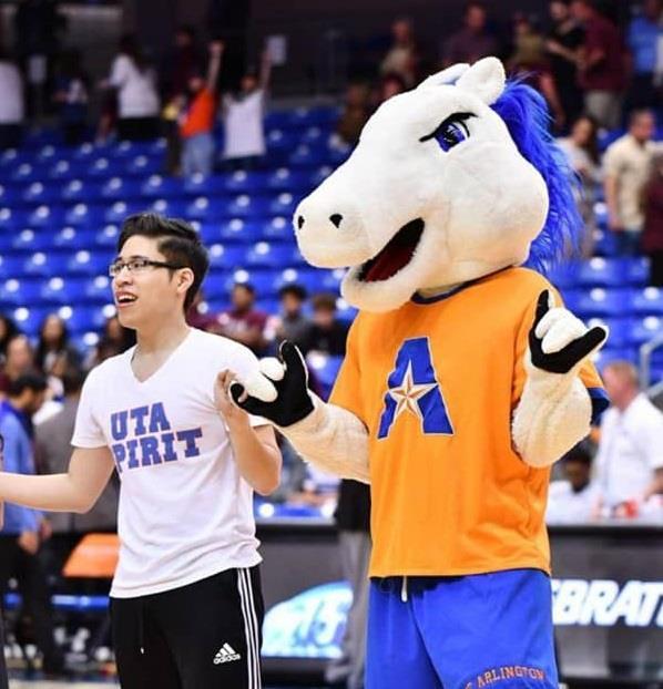 Mascot Blaze performing at a UTA game in front of stands