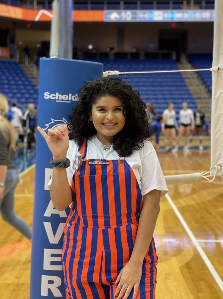 Wrangler Alexa Alaniz maving up at an indoor volleyball court