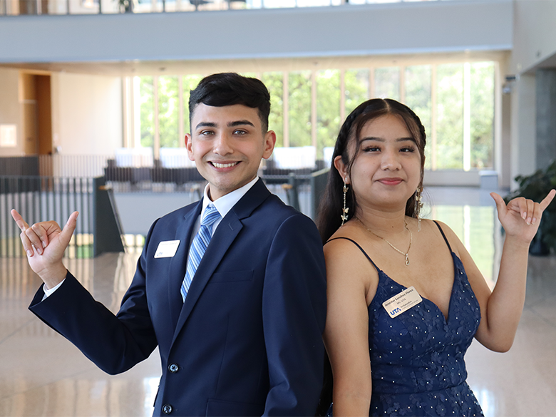 photo of Mr. and Ms. UTA holding up MavUp sign