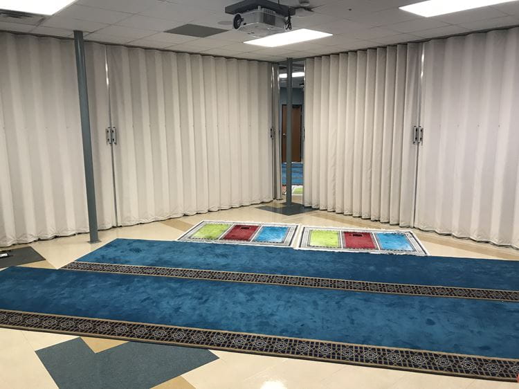 Picture of a reflection room with prayer mats