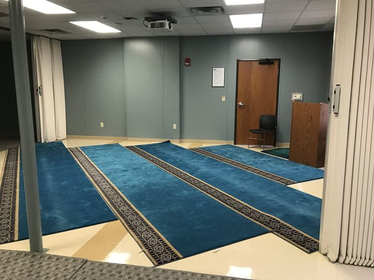 Picture of the reflection room with prayer mats