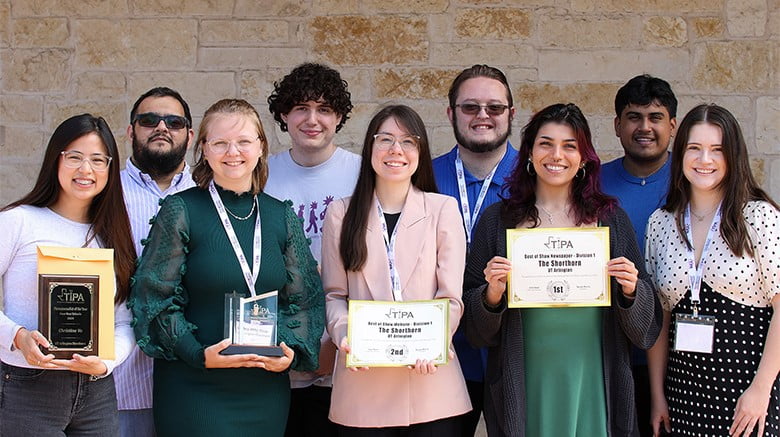 The Shorthorn staff holding awards and posing for a group photo