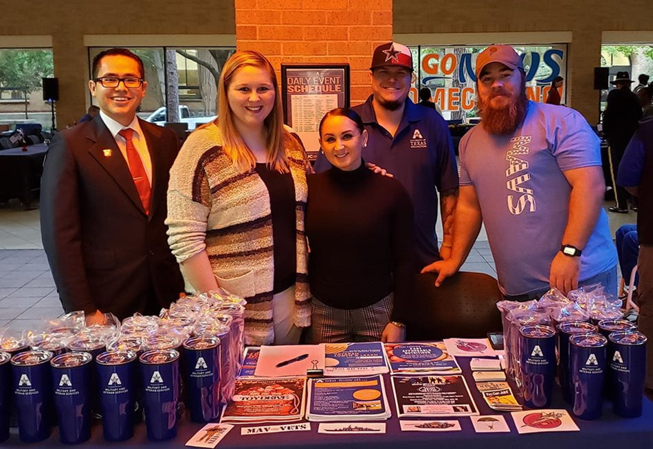 People behind table full of concessions in front of palo duro