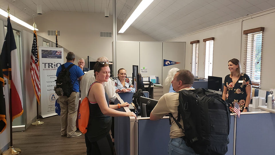 Group of people chatting at check-in.