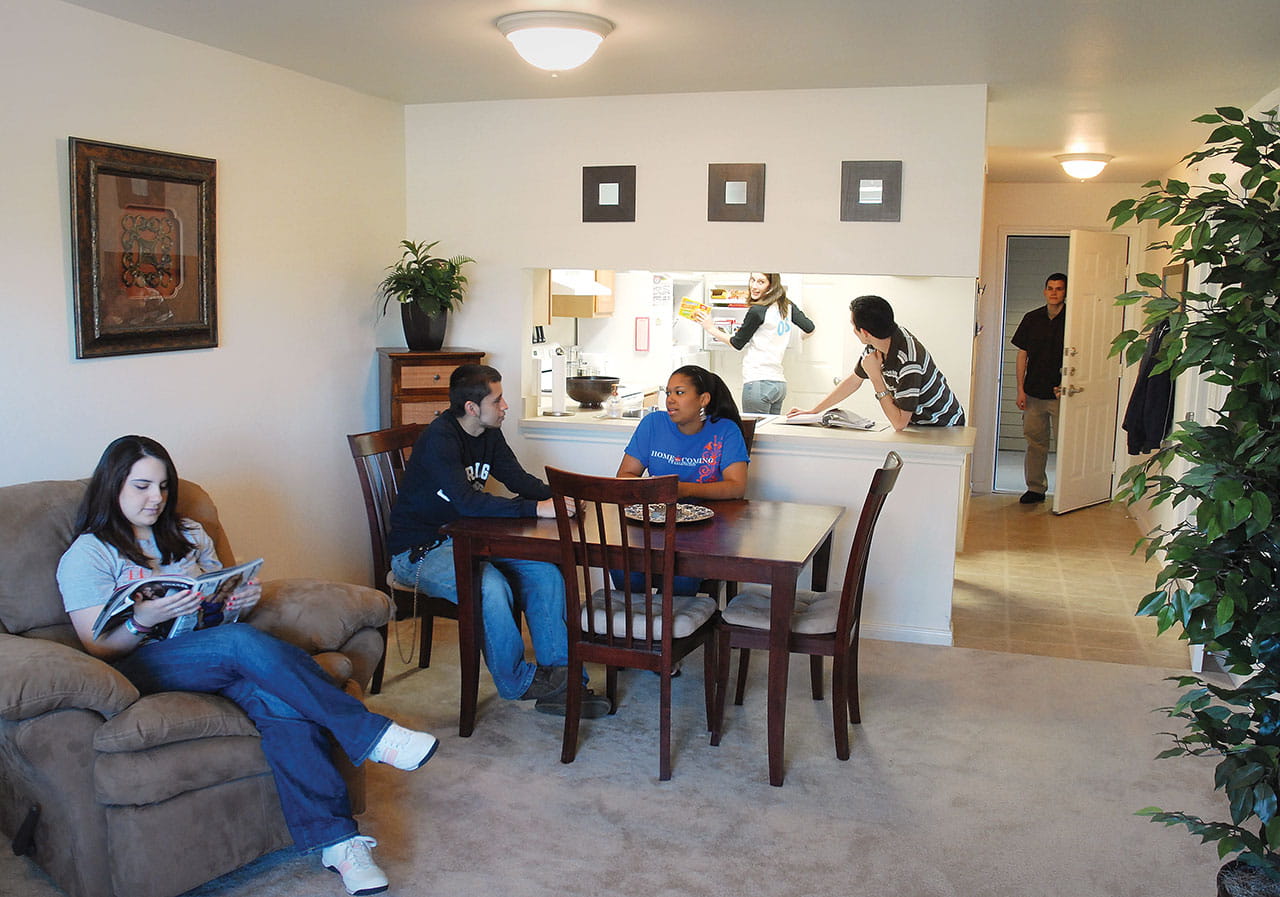 students sitting in their apartment