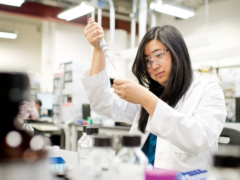 Graduate Student evelyn wang working in a lab