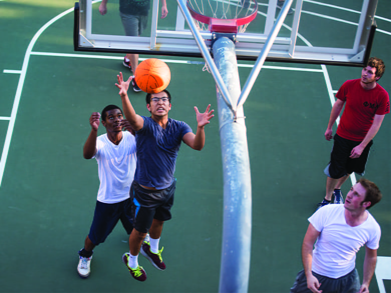 Students playing basketball outside of the MAC