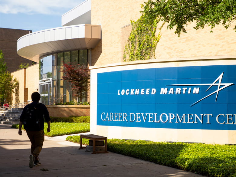 Student in front of the Lockheed Martin Career Development Center